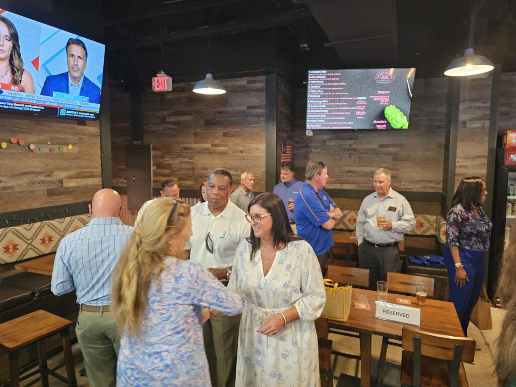 Members of NDIA First Coast Chapter network at the 2024 social event at 2nd Bay Brewing Co.