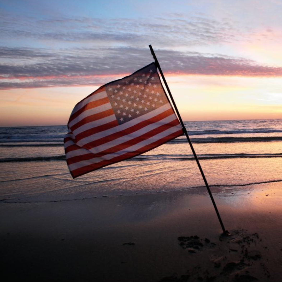 An american flag blowing in the wind on a Florida Beach